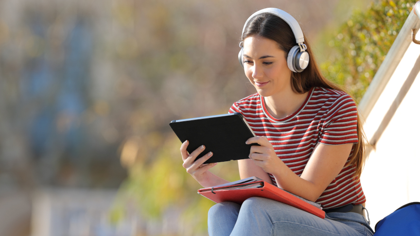 Student Learning With Tablet And Headphones
